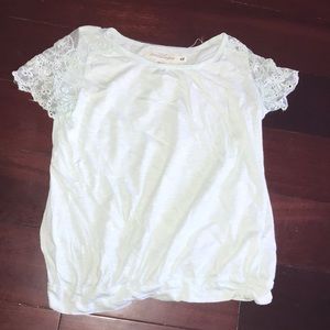 A pastel blue t-shirt with ruffle-like material